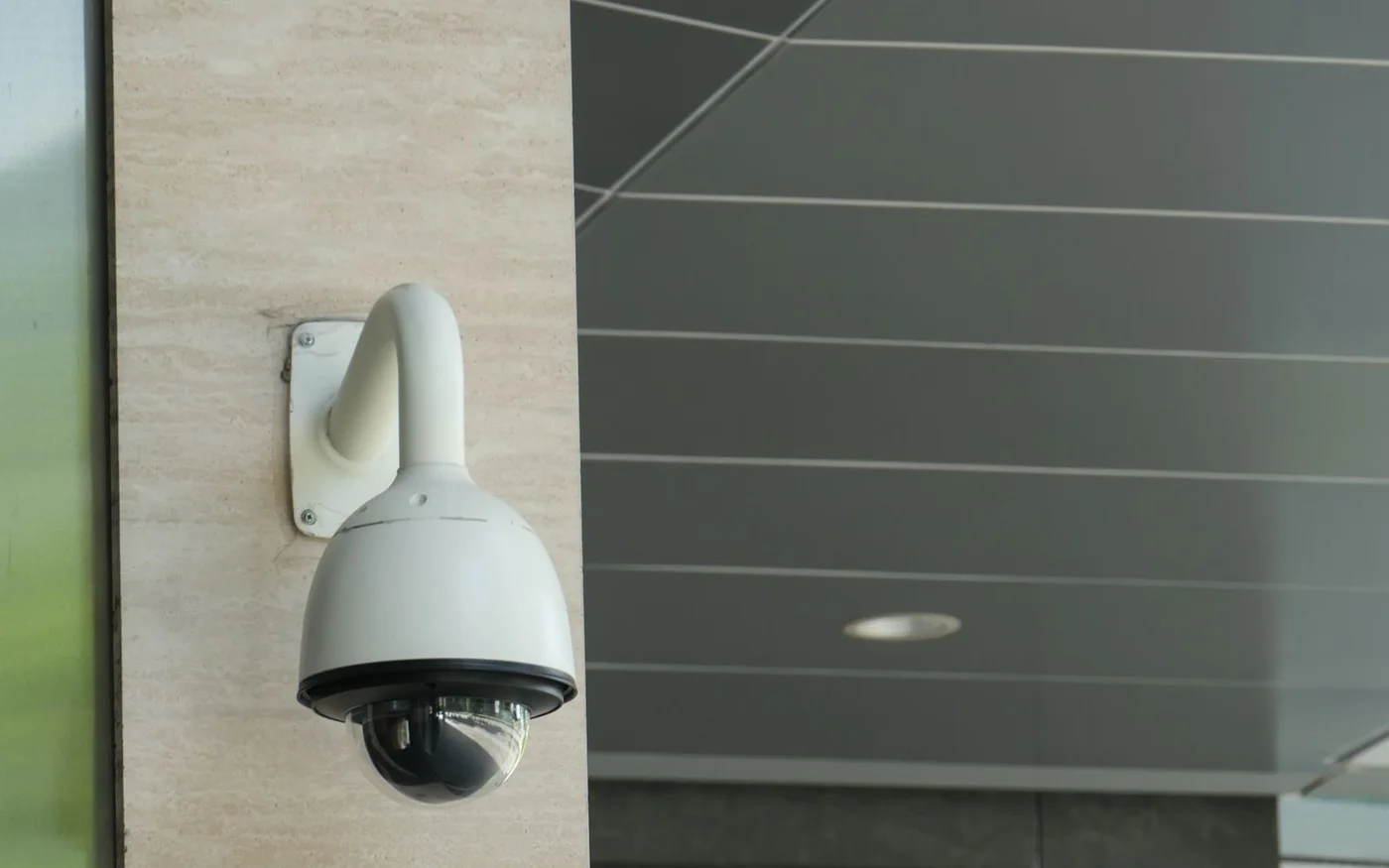 Une caméra de surveillance sur un bâtiment rappelle que les outils de protection exigent un mandat précis et des contrôles indépendants.